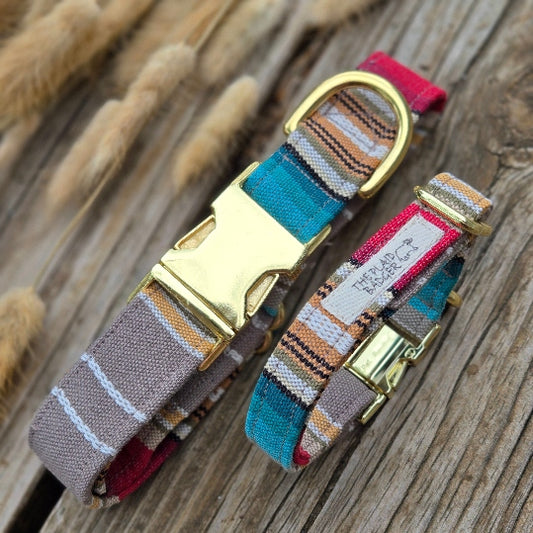 taupe, white, mustard yellow, red, turquoise and black stripes all in different weights arranged beautifully in a Southwest style pattern. Photo shows large collar, and small collar, making this perfect for a large and small dog. fabric is woven mid-weight cotton. Shown with shiny gold metal heavy duty buckles.