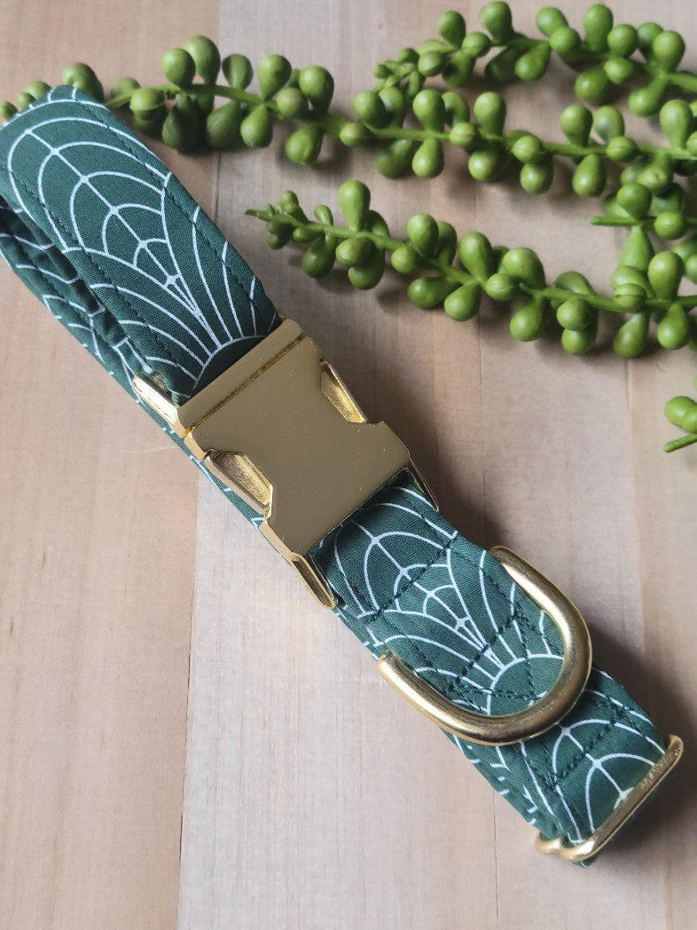 art deco dog collar, white curved lines on dark green background, gold hardware