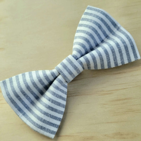 lovely linen dog bow tie made with thin blue and white pinstripes arranged vertically. classic design. elastics on backside for slipping over collar