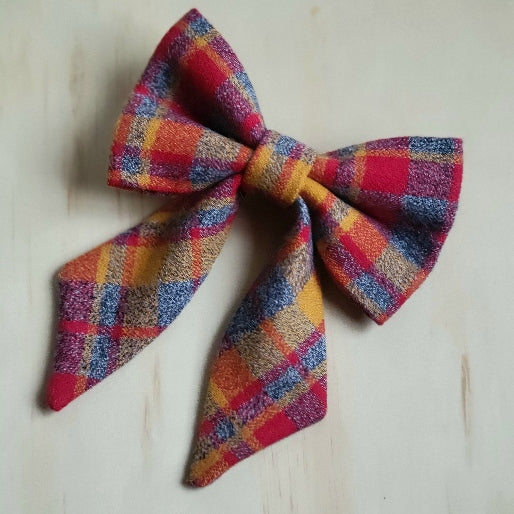 red and yellow plaid flannel on medium gray background, kansas city chiefs themed fancy girl dog bow 
