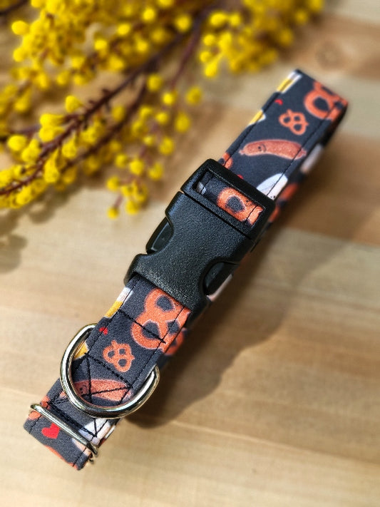 oktoberfest themed dog collar with happy sausages, pretzels, beers and hearts on a black background