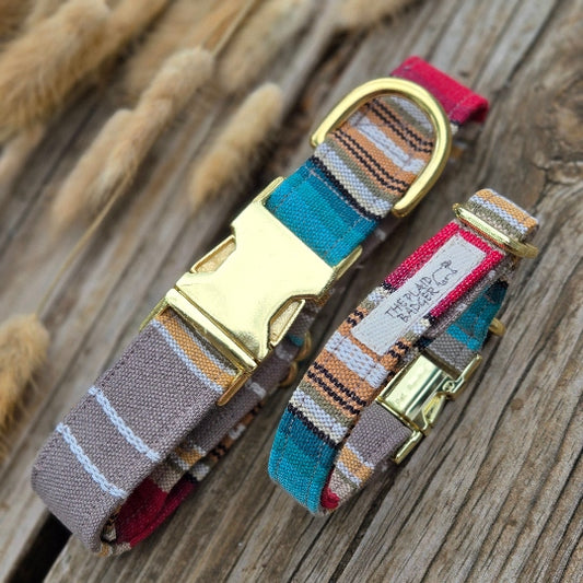 taupe, white, mustard yellow, red, turquoise and black stripes all in different weights arranged beautifully in a Southwest style pattern. Photo shows large collar, and small collar, making this perfect for a large and small dog. fabric is woven mid-weight cotton. Shown with shiny gold metal heavy duty buckles. 