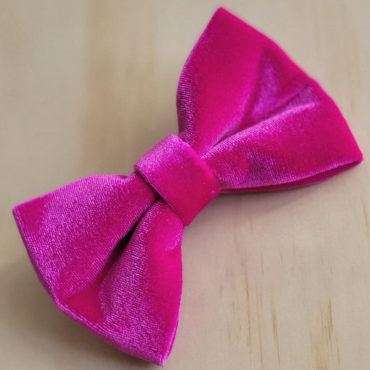 velvet bow tie in hot barbie pink. soft to the touch with a lovely shine. removable and easily slips over collar.