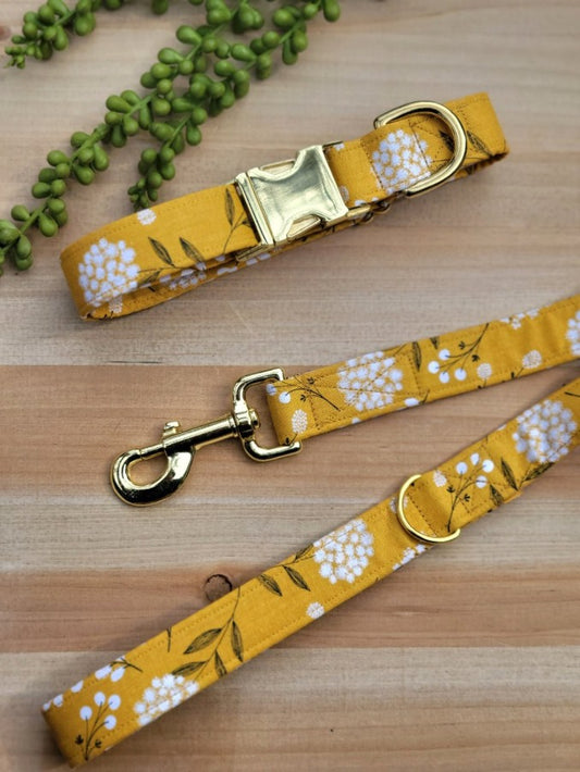 whimsical white blooms on mustard yellow background dog collar, leash, and waste bag set