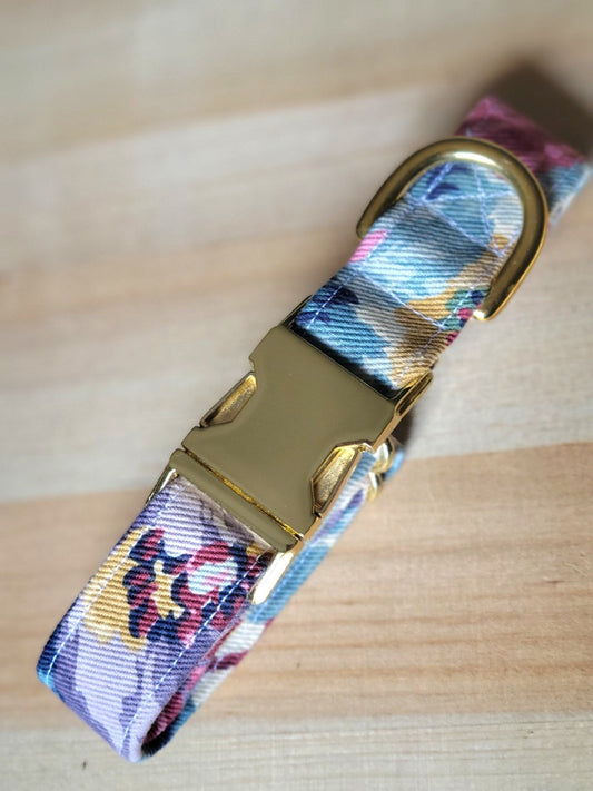 dog collar made with vintage denim from the 80s or 90s. Collar features muted hues of purple, pink, burgundy, yellow, and sky blue on a white background. Floral pattern is more abstract. Unique.