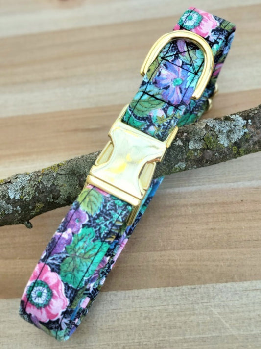 gorgeous handmade dog collar with vintage florals typical of the 1950s bright pops of color on a black background